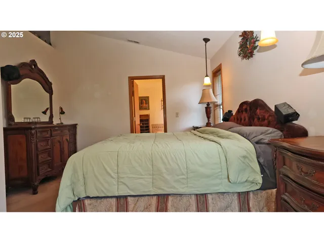 a bed room with a bed window and a mirror