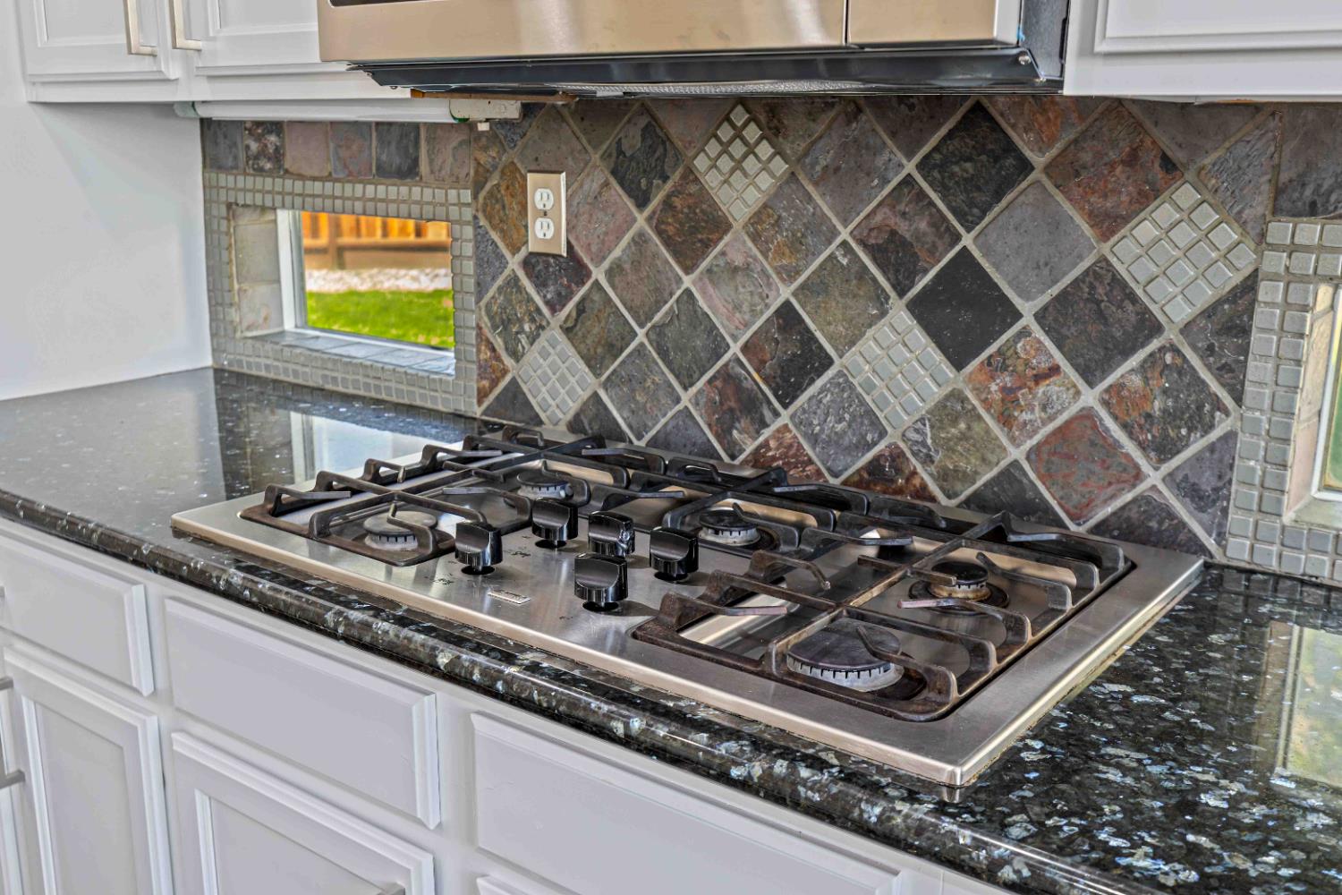 3913 Bayview Drive Modesto, CA 95355 - Photo 12 of 47 a stove top oven sitting inside of a kitchen
