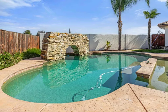 a view of a swimming pool with a yard