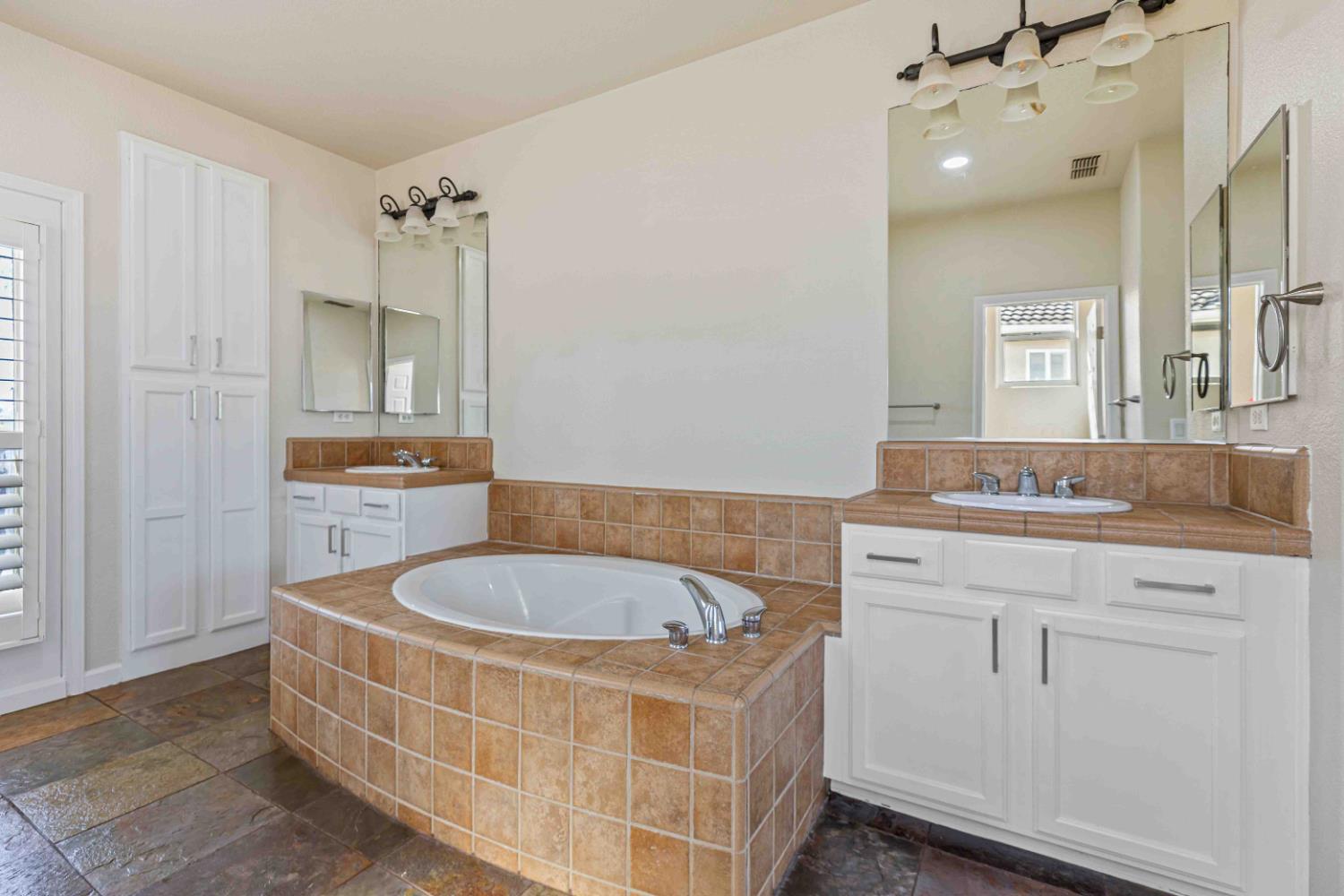 3913 Bayview Drive Modesto, CA 95355 - Photo 20 of 47 a spacious bathroom with a tub sink and mirror