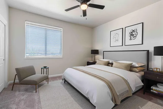 a bedroom with bed and a couch