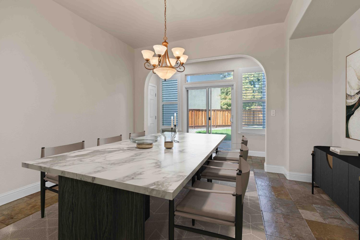 3913 Bayview Drive Modesto, CA 95355 - Photo 8 of 47 a view of a dining room with furniture a chandelier and wooden floor