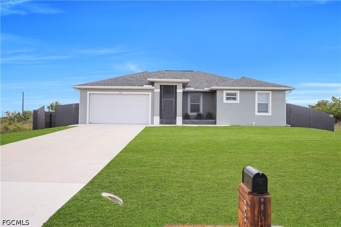 384 Neighborly Road LaBelle, FL 33935 - Photo 2 of 45 a front view of a house with a yard