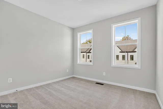 an empty room with windows and closet