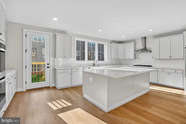 a kitchen with stainless steel appliances granite countertop a stove and a sink