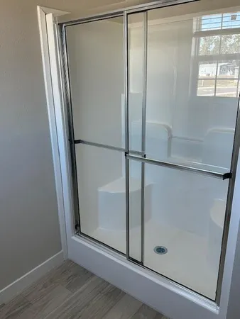 a bathroom with a glass shower door