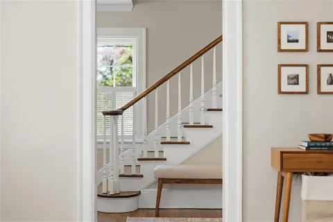 a view of entryway and hall with wooden floor