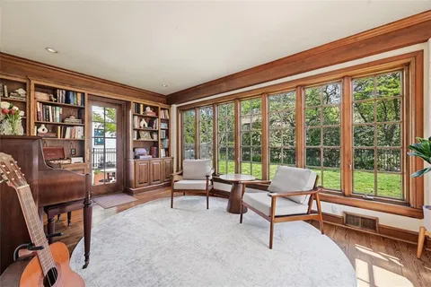 a living room with furniture and a floor to ceiling window
