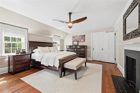 a bedroom with a bed and a fireplace