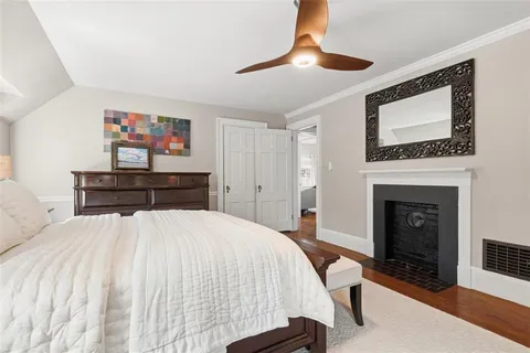 a bedroom with a large bed and a fireplace