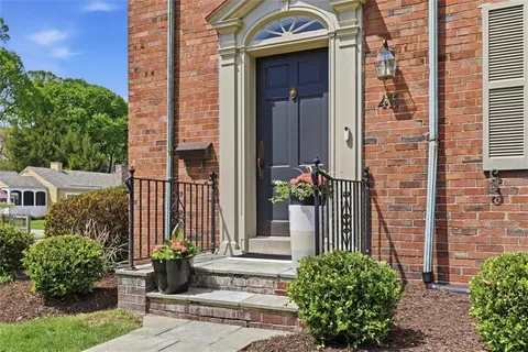 a front view of a house with a garden