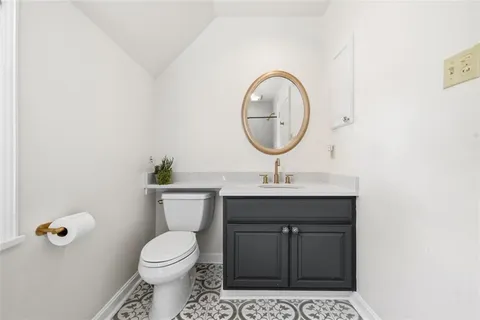 a bathroom with a sink a toilet and a shower