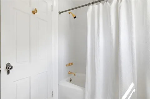 a bathroom with a shower and a shower curtain