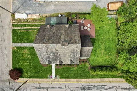 an aerial view of a house with a yard