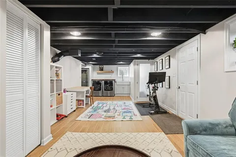 a living room with stainless steel appliances kitchen island granite countertop furniture and a fireplace