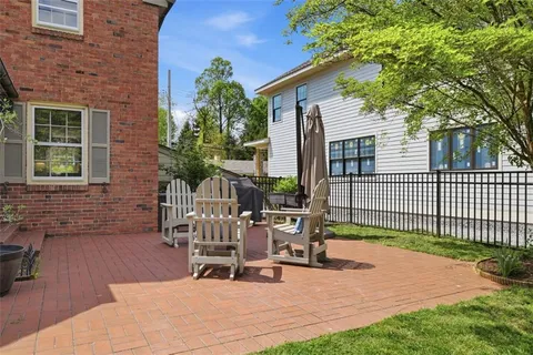 a view of a house with backyard and sitting area