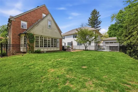 a view of a house with a backyard