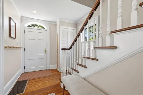 a view of entryway with wooden floor and stairs