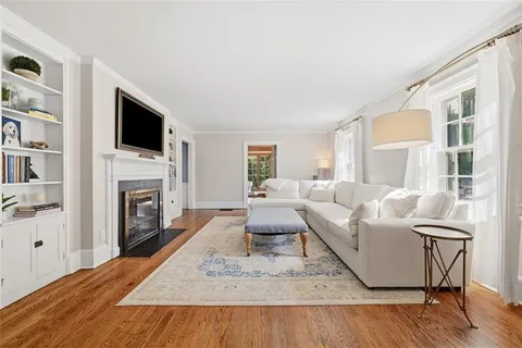 a living room with furniture fireplace and flat screen tv