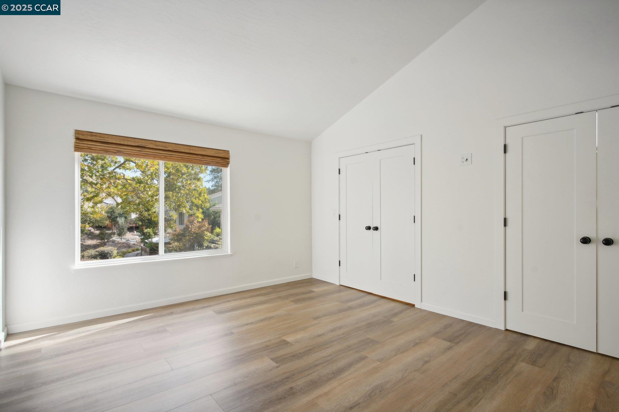 119 Cypress Point Way Moraga, CA 94556 - Photo 14 of 38 a view of an empty room with wooden floor and a window