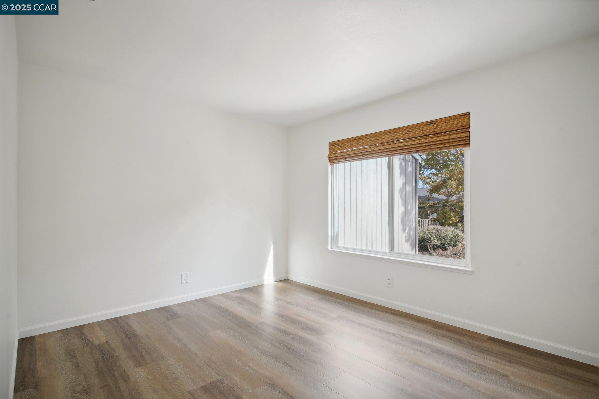 119 Cypress Point Way Moraga, CA 94556 - Photo 22 of 38 an empty room with wooden floor and windows