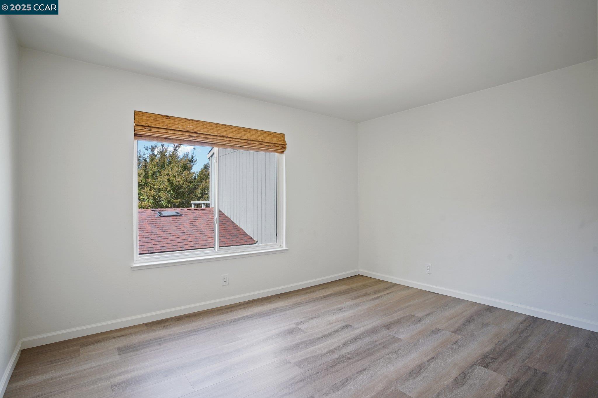 119 Cypress Point Way Moraga, CA 94556 - Photo 24 of 38 a view of an empty room with wooden floor and a window