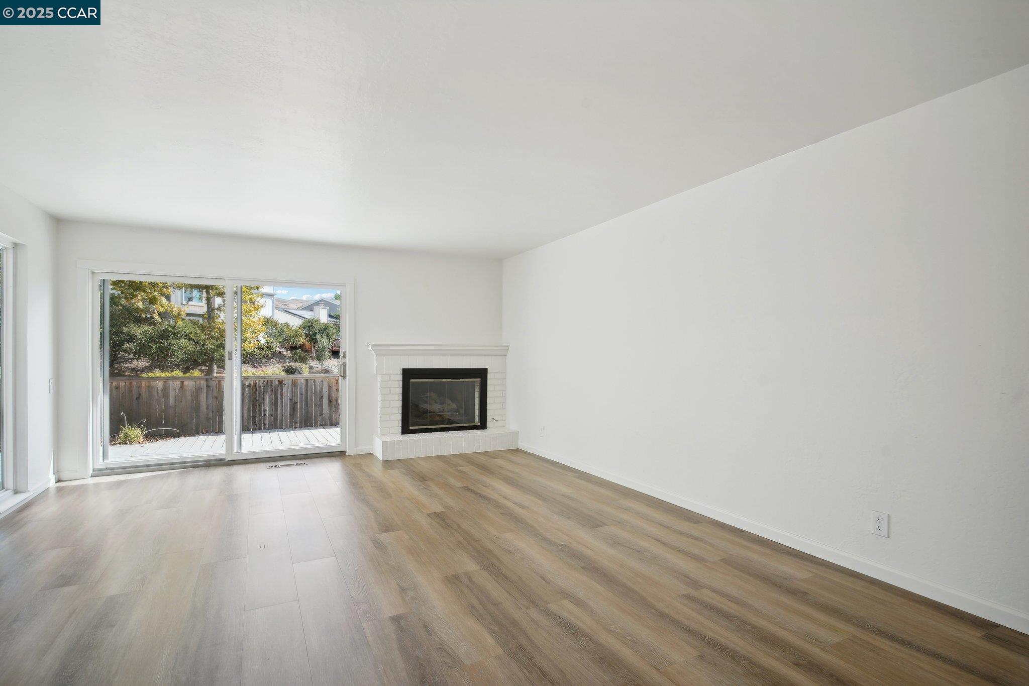 119 Cypress Point Way Moraga, CA 94556 - Photo 4 of 38 a view of an empty room with wooden floor and a window
