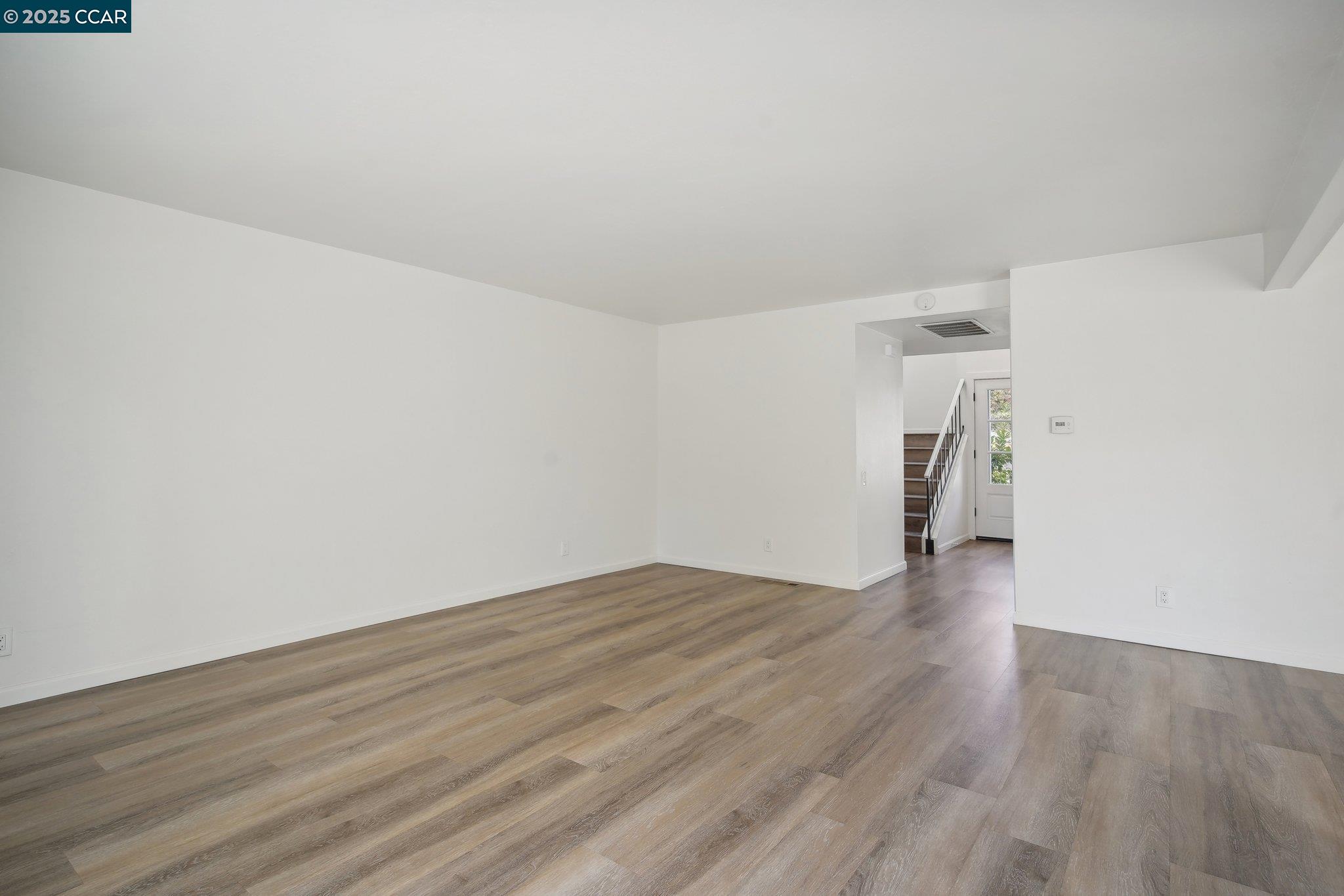119 Cypress Point Way Moraga, CA 94556 - Photo 6 of 38 a view of an empty room with wooden floor and a window