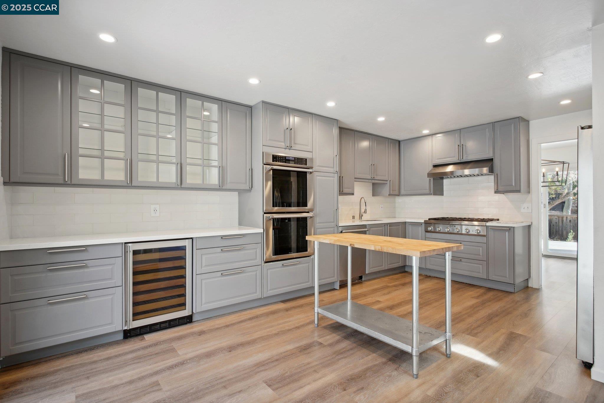 119 Cypress Point Way Moraga, CA 94556 - Photo 9 of 38 a kitchen with white cabinets and stainless steel appliances