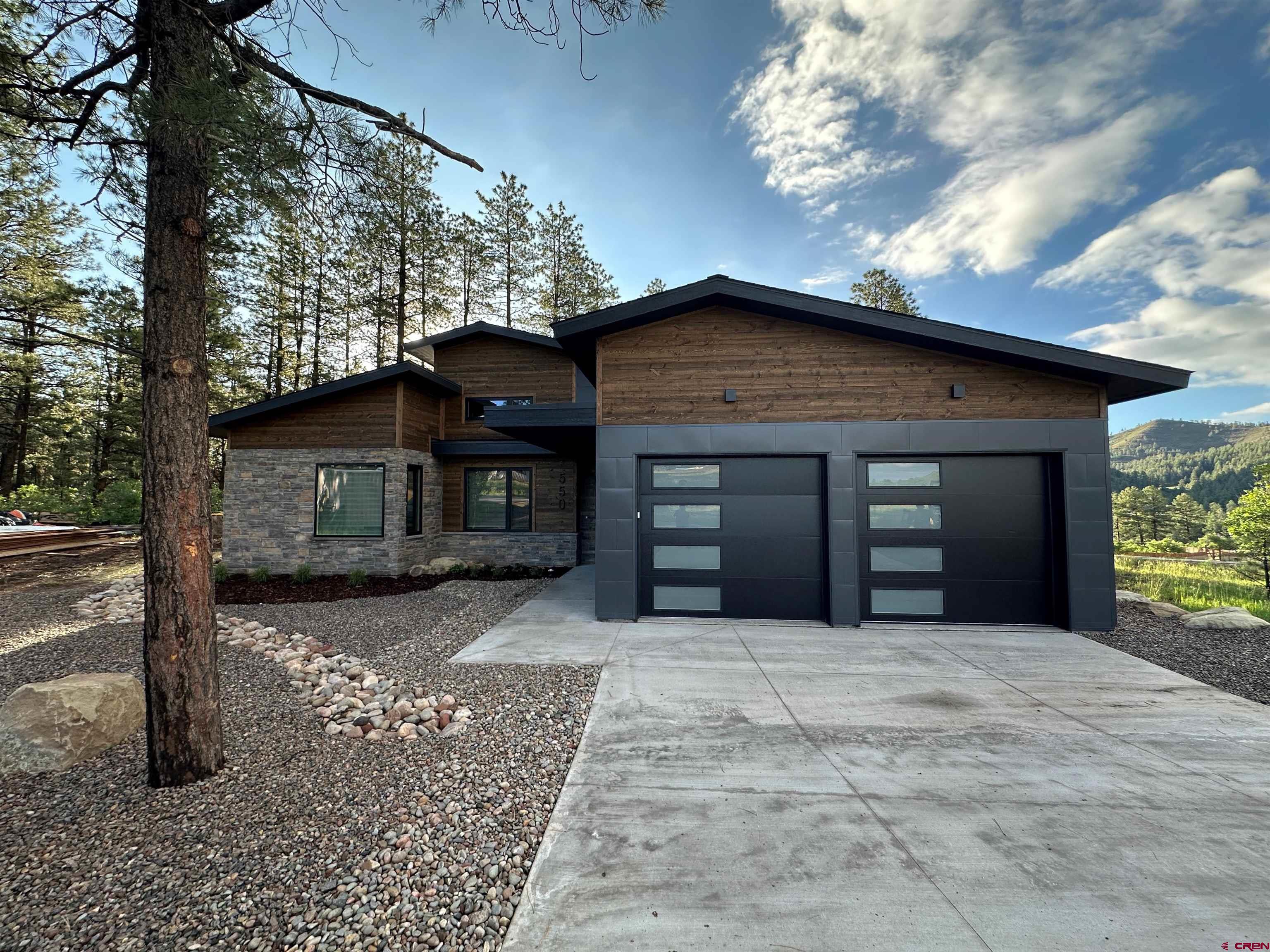 550 Edgemont Meadows Road Durango, CO 81301 - Photo 1 of 4 a front view of a house with a yard and garage