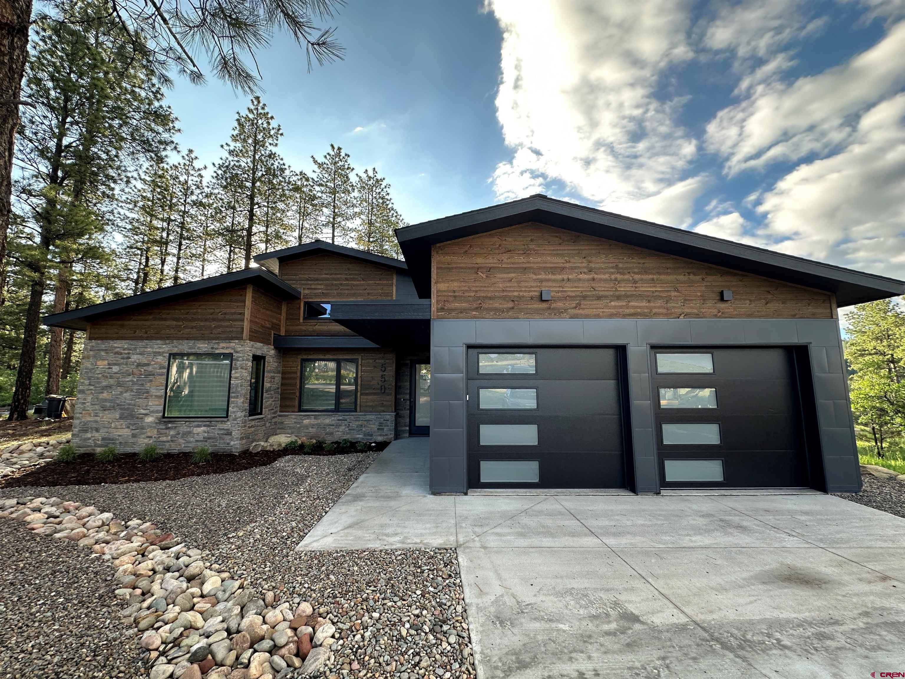 550 Edgemont Meadows Road Durango, CO 81301 - Photo 3 of 4 a front view of a house with a yard