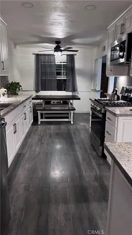 a kitchen with stainless steel appliances granite countertop a stove and a sink