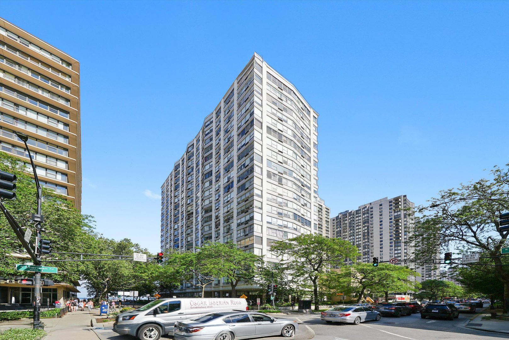 a view of a buildings and car parked on the roadside