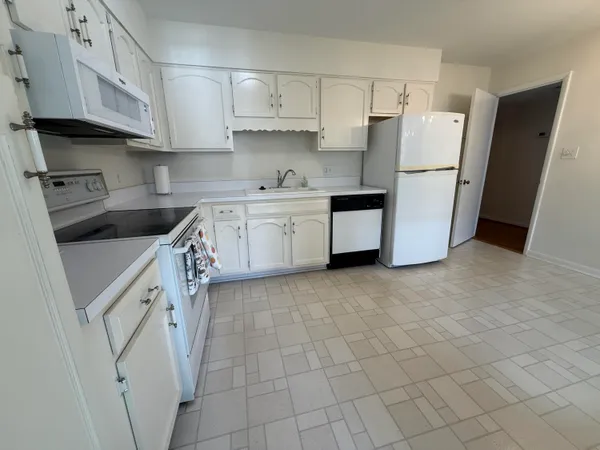a kitchen with stainless steel appliances granite countertop a refrigerator a stove a sink and dishwasher