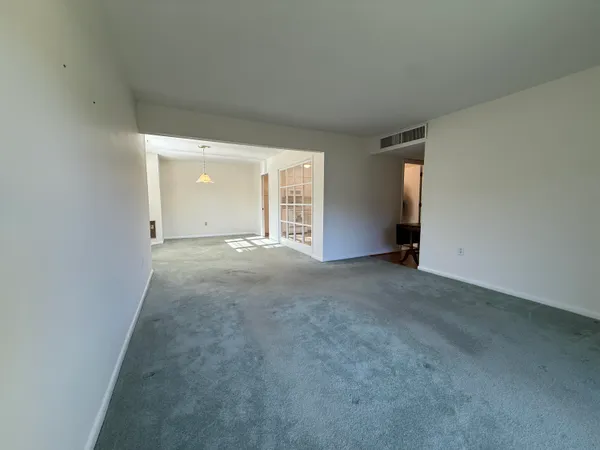 an empty room with windows and entrance