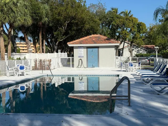 a view of house with swimming pool outdoor seating