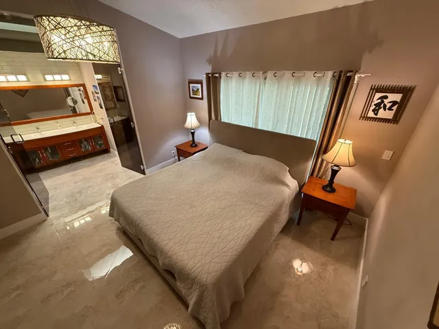 a bed sitting in a room next to a window