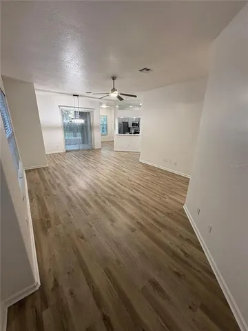 a kitchen with granite countertop a refrigerator and a stove top oven