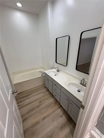 a view of a room with wooden floor