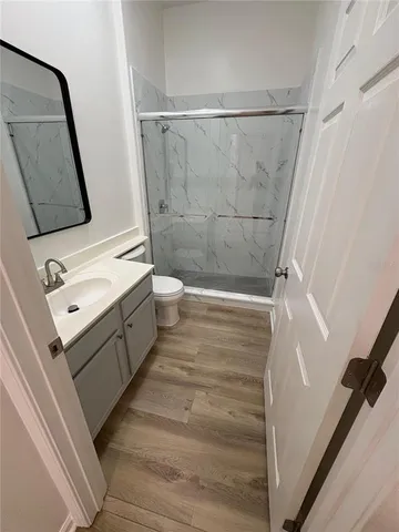 a bathroom with a double vanity sink toilet and shower