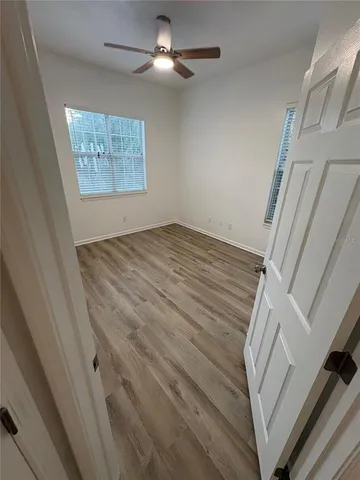 an entryway with wooden floor and staircase