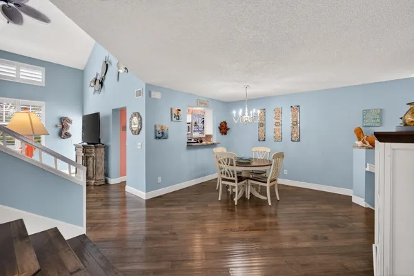 a dining room with furniture and wooden floor