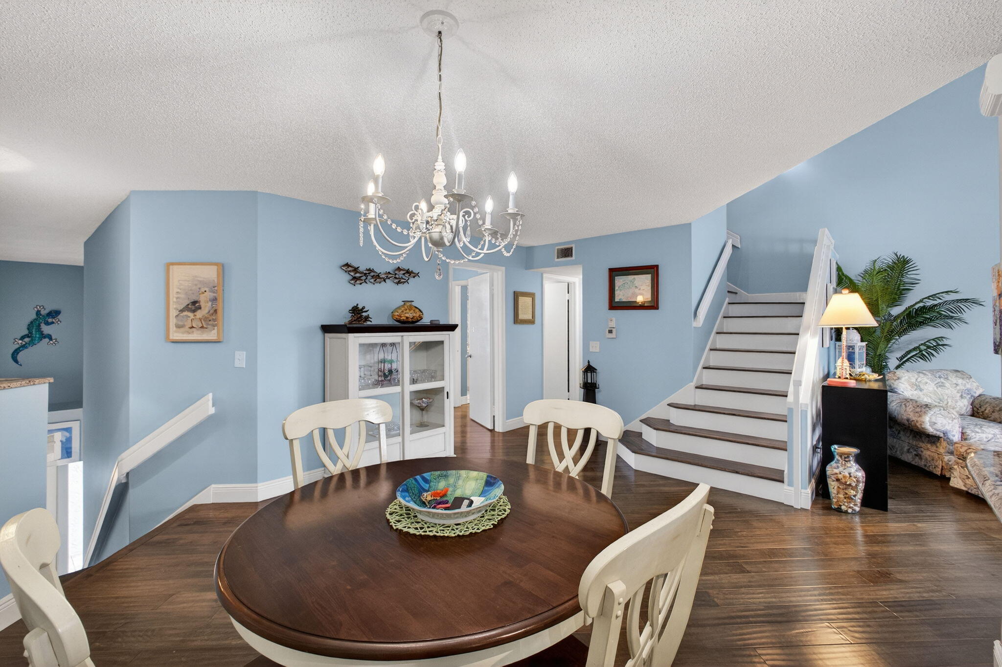 1206 Mainsail Circle Jupiter, FL 33477 - Photo 17 of 46 a dining room with furniture a chandelier and wooden floor