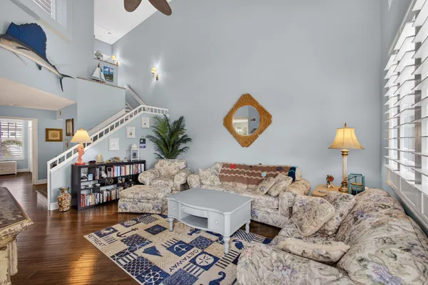a living room with furniture and wooden floor