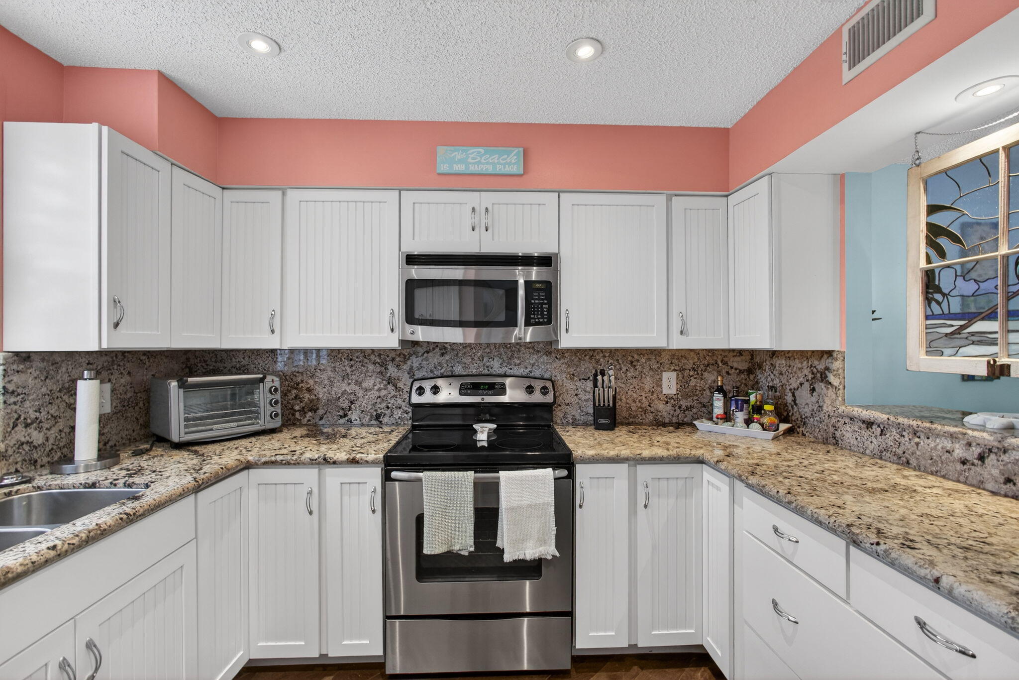 1206 Mainsail Circle Jupiter, FL 33477 - Photo 27 of 46 a kitchen with stainless steel appliances granite countertop a sink stove and cabinets