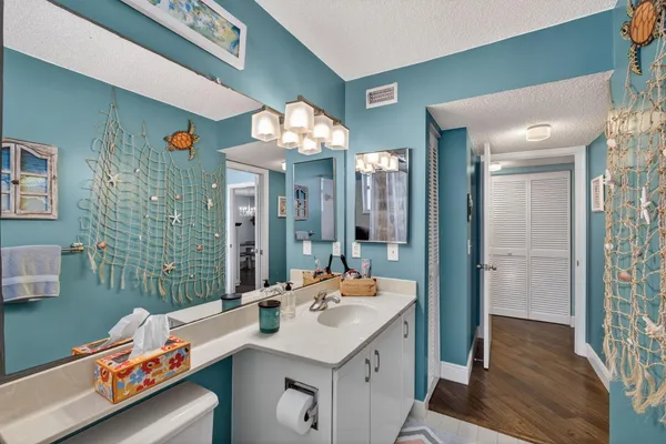 a bathroom with a sink vanity granite and a mirror