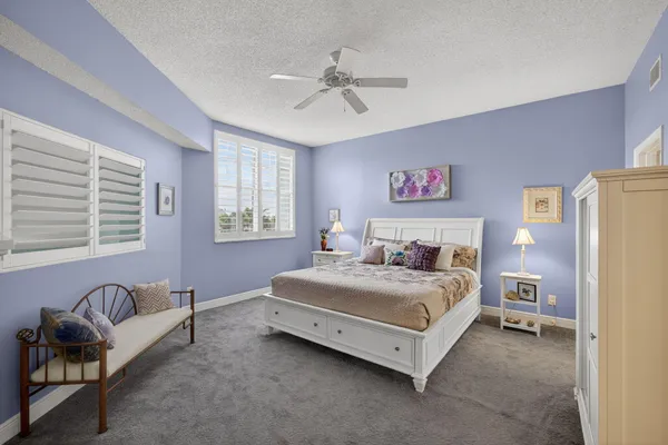 a bedroom with a bed couch and window