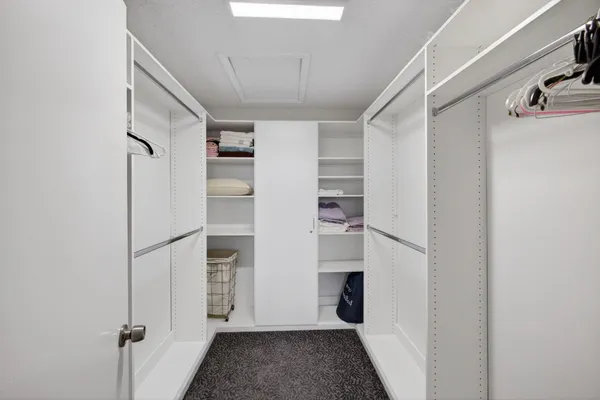 a view of walk in closet with empty racks