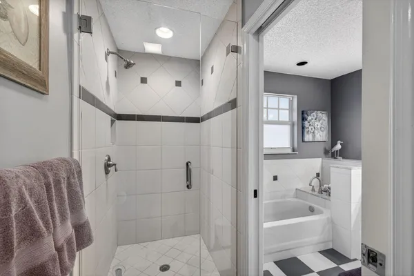 a bathroom with a bathtub and a shower