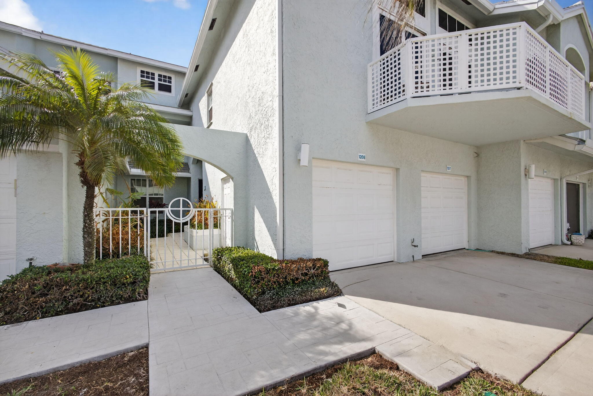 1206 Mainsail Circle Jupiter, FL 33477 - Photo 9 of 46 a view of a house with a yard and potted plants